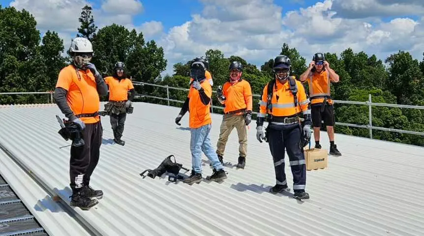 The Streamline crew on a roof